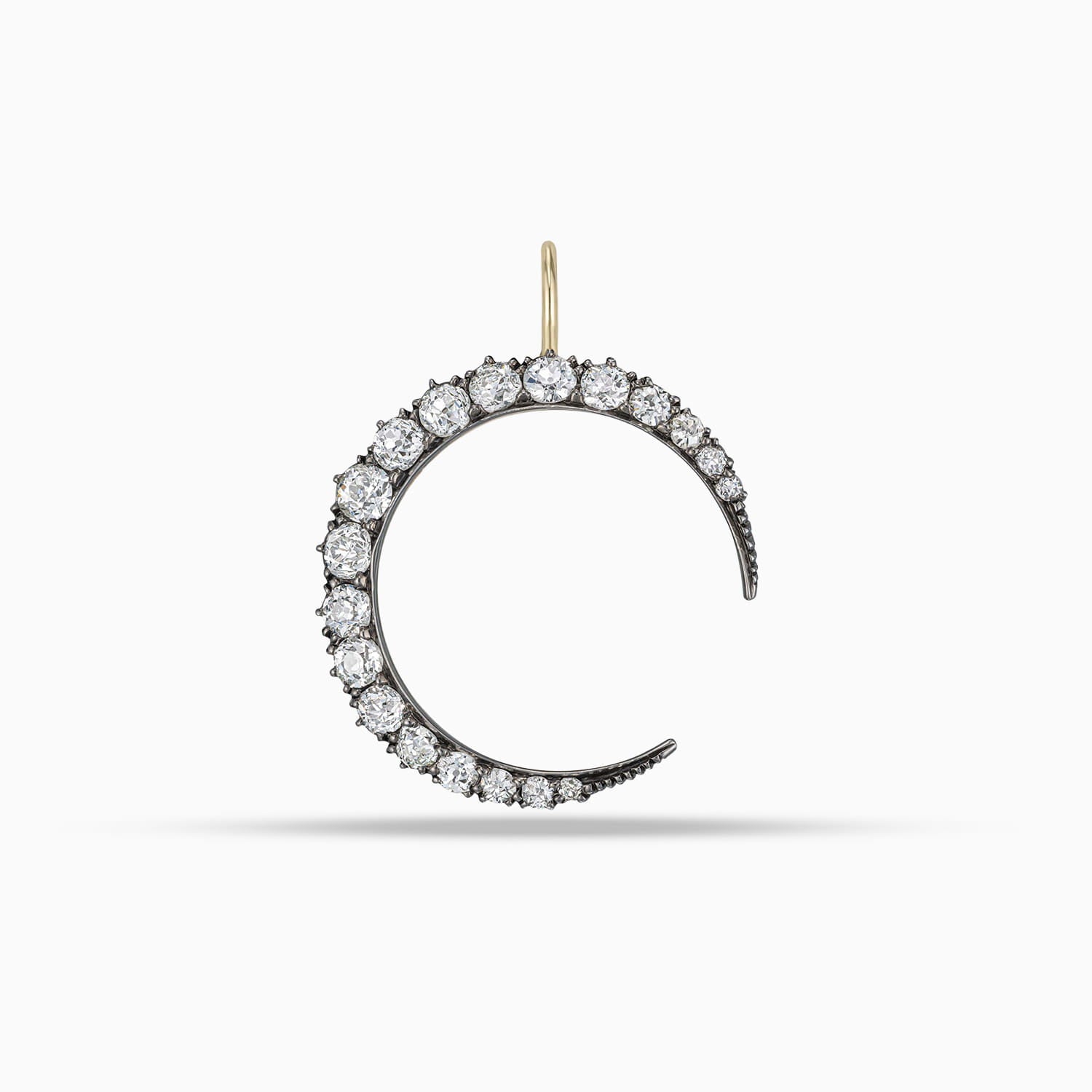 Antique diamond crescent moon pendant with old mine cut diamonds in silver on gold