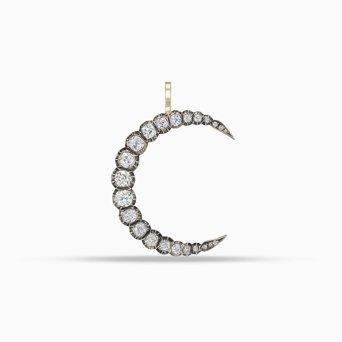 Antique graduating diamond crescent moon pendant with old mine cut diamonds in silver on gold