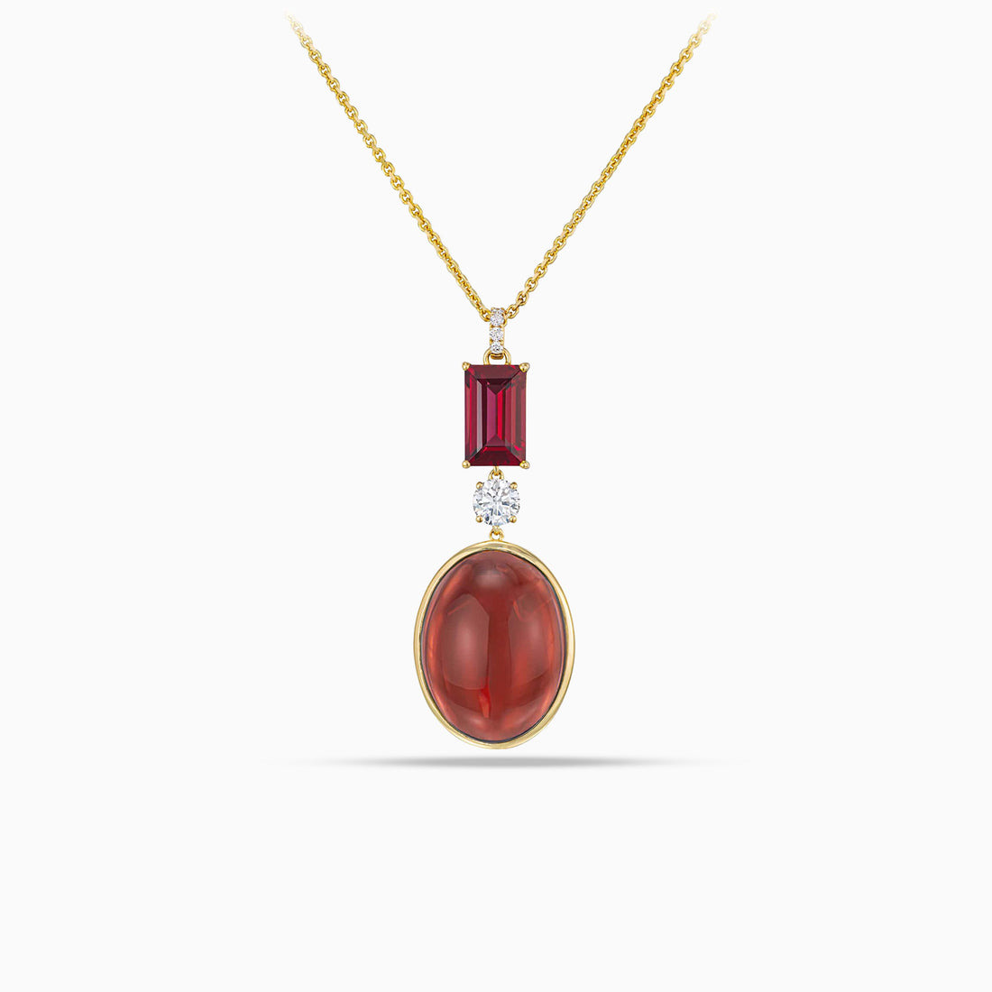 Cabochon garnet pendant with round brilliant cut diamond and baguette garnet in 18K yellow gold