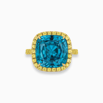 Cushion shape blue zircon ring with yellow sapphire halo in 18K yellow gold