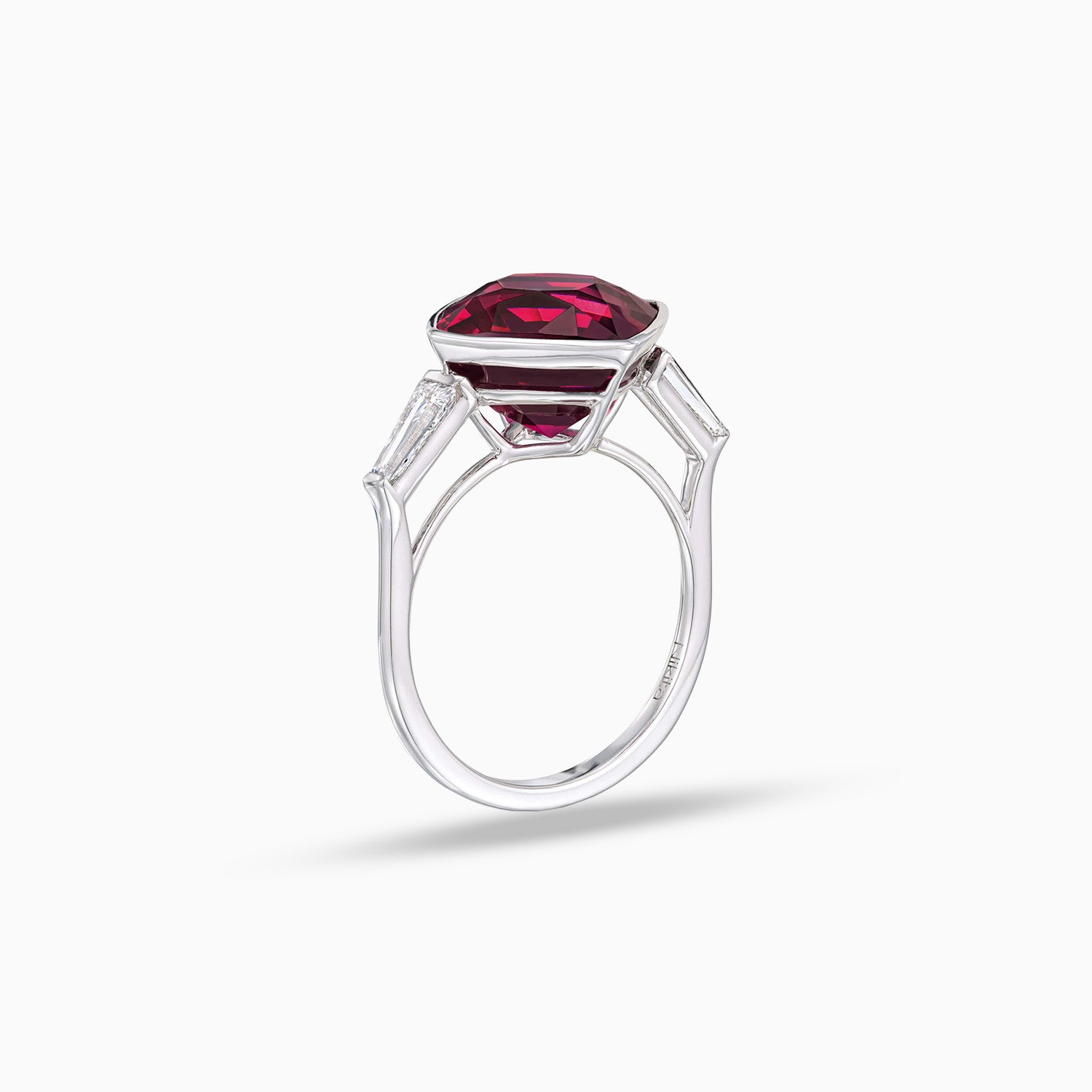 Side view of cushion shape rhodolite garnet ring with tapered baguette diamonds in 18K white gold
