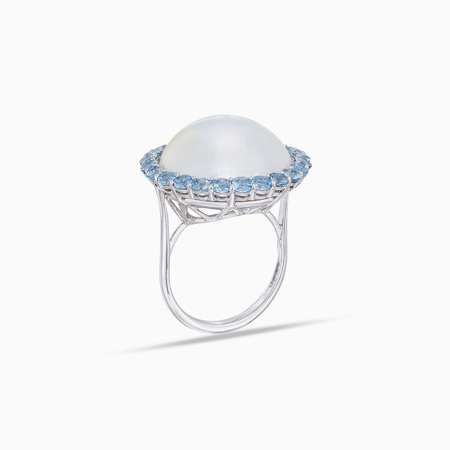 Side view of mabe cultured pearl dome ring with aquamarine halo in 18K white gold