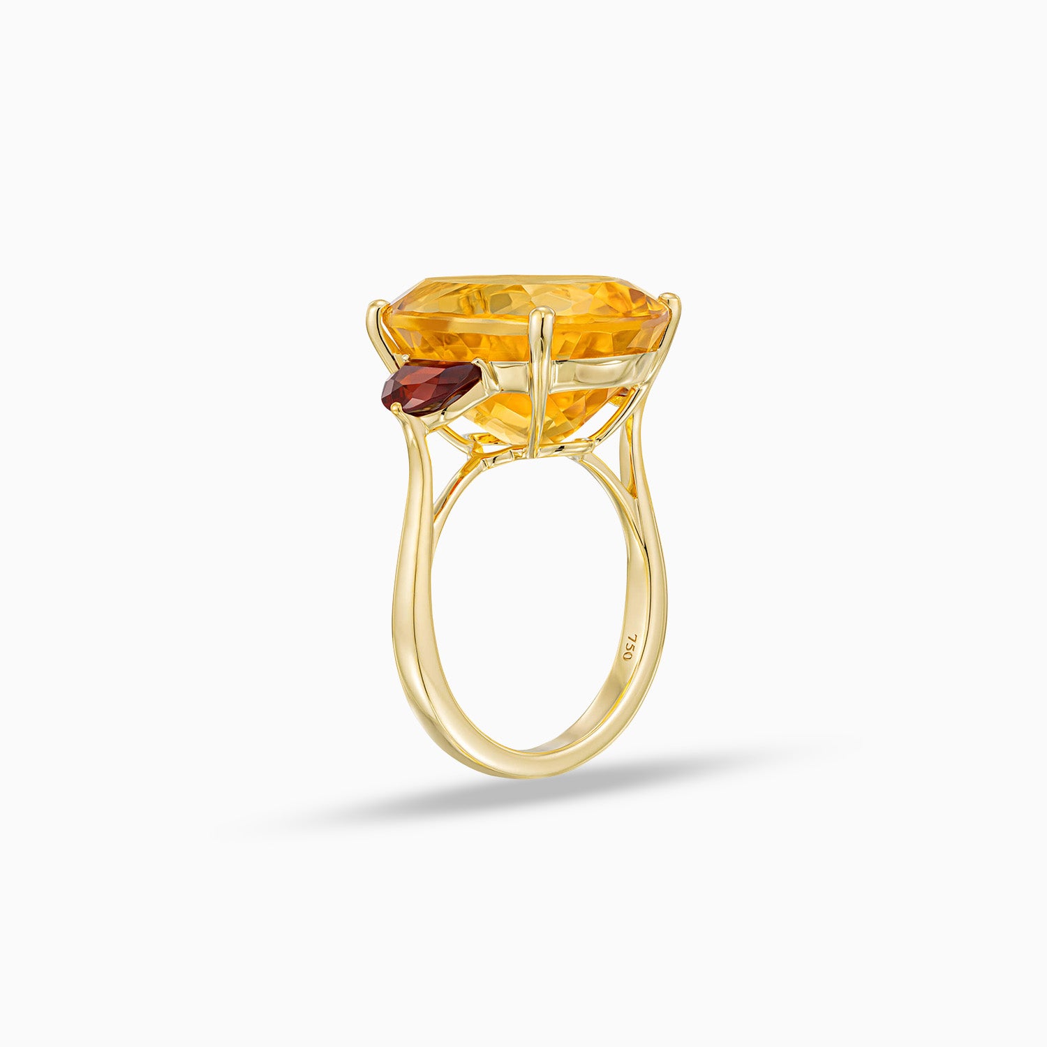 Side view of oval shape citrine ring with half moon red garnet side stones in 18K yellow gold