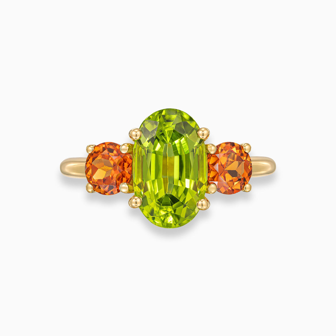 Oval shape peridot ring with round spessartite garnet side stones in 18K yellow gold