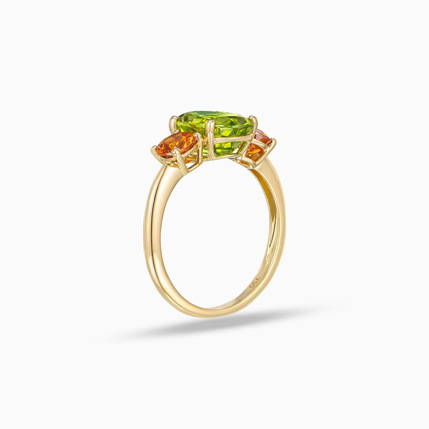Side view of oval shape peridot ring with round spessartite garnet side stones in 18K yellow gold