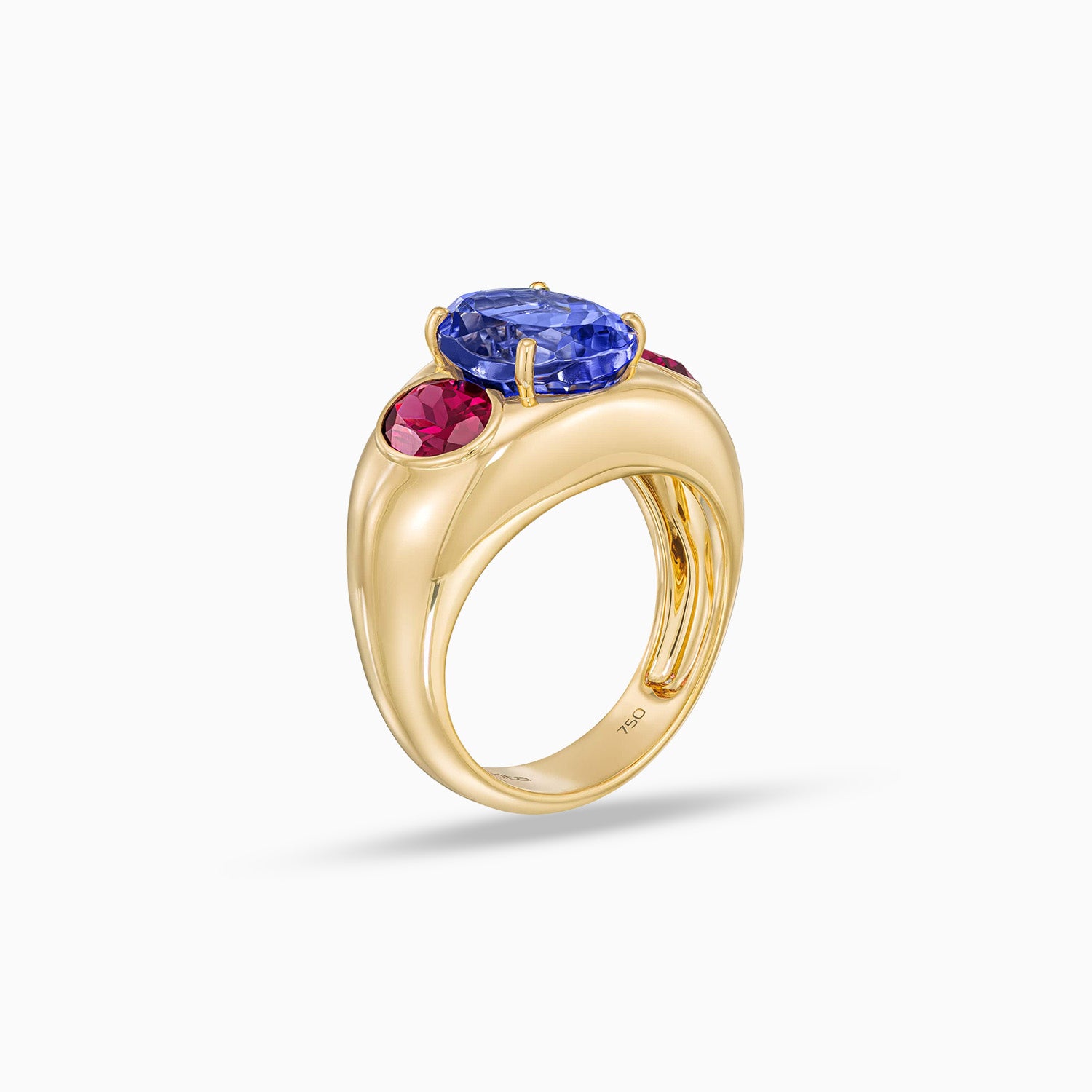 Side view of oval tanzanite ring with grape garnet side stones in 18K yellow gold